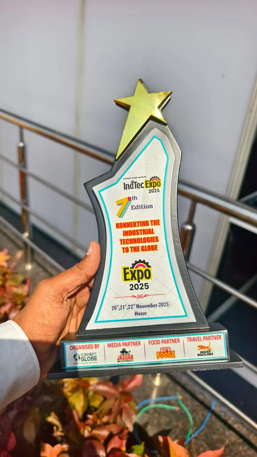 Hand holding the INDTEC EXPO edition badge
