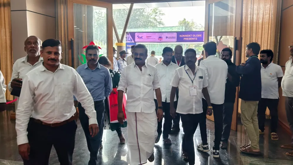 Group of visitors gathered at an exhibitor counter