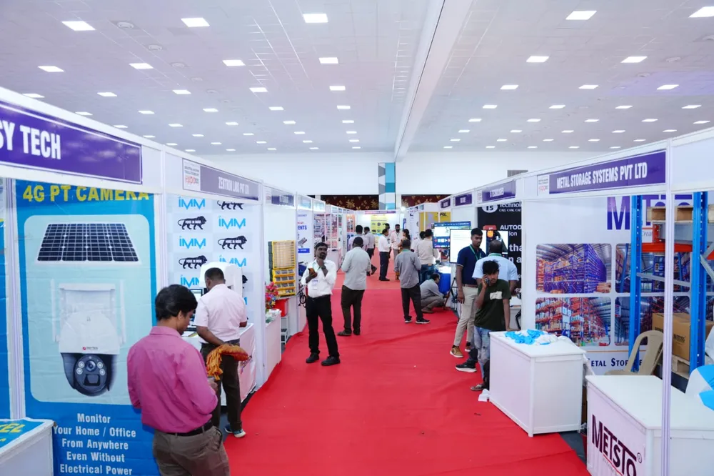 Wide view of the exhibition hall aisle with booths on both sides